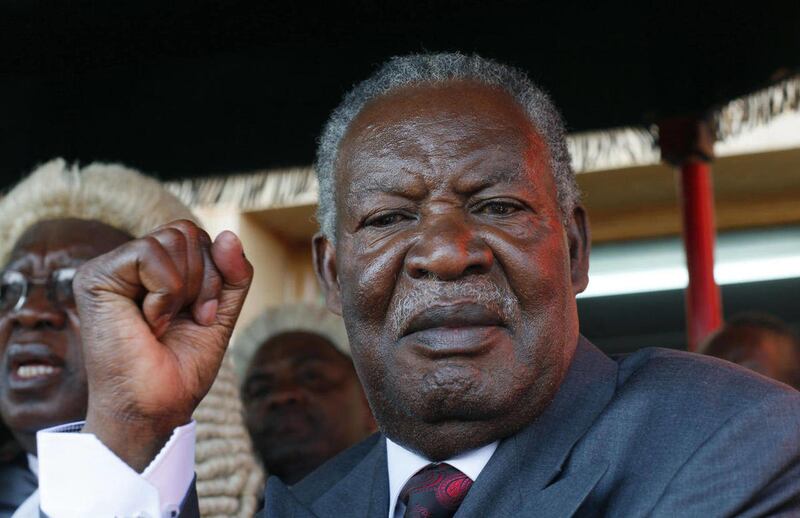 FILE - In this Sept. 23, 2011 file photo, Zambia's new President Michael Sata waves at supporters after taking the oath of office on the steps of the supreme court in Lusaka, Zambia. In just two weeks in office, Zambia's president has replaced the country
