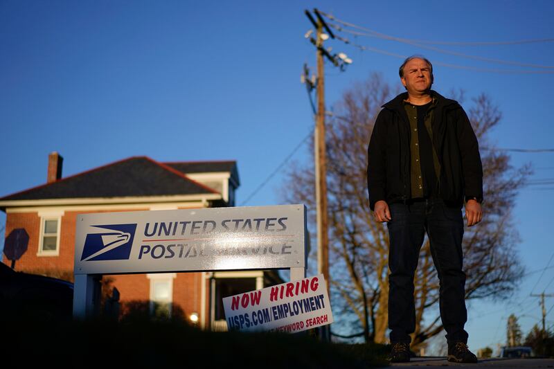 Gerald Groff, a former postal worker, stands near a “Now Hiring” sign for the United States Postal Service in Quarryville, Pa.