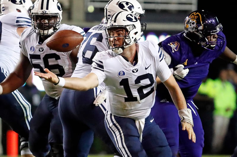BYU quarterback Tanner Mangum loses control of the ball during game against East Carolina in Greenville, N.C., Saturday, Oct. 21, 2017.
