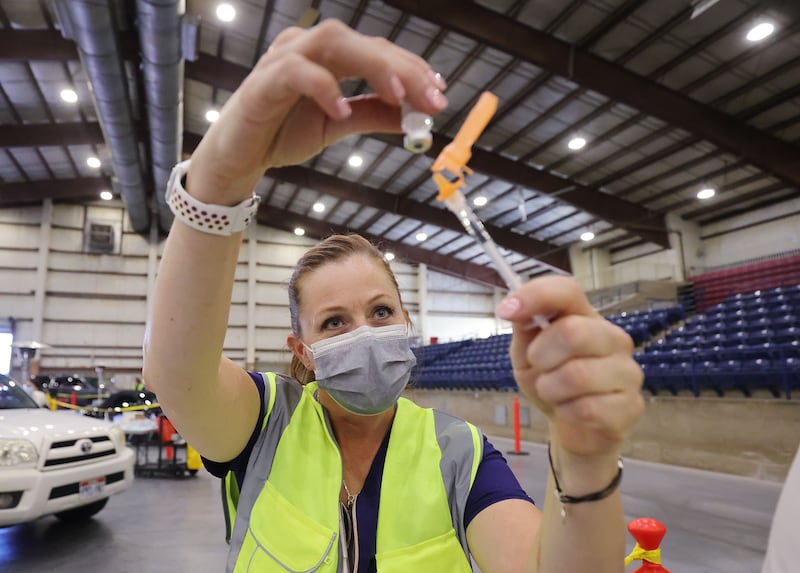 Annie Sullivan draws a COVID-19 vaccine at the Legacy Events Center in Farmington, Utah.