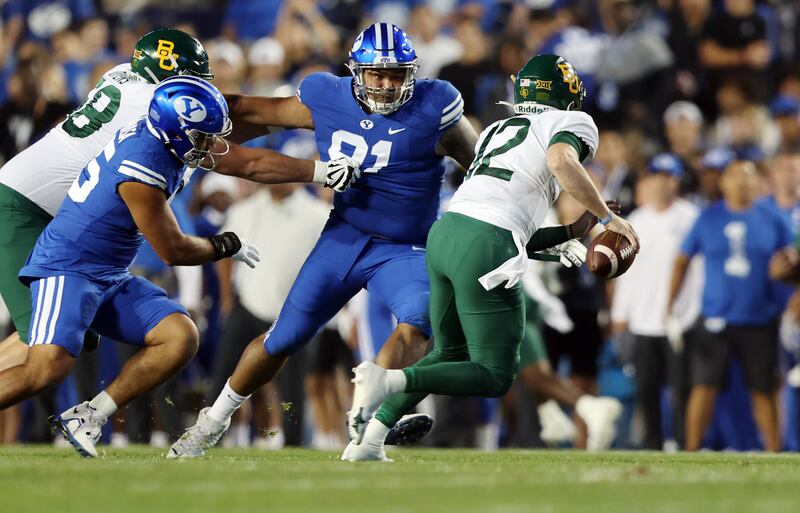 Brigham Young Cougars defensive lineman Pepe Tanuvasa (45) and Brigham Young Cougars defensive lineman Earl Tuioti-Mariner (91) chase Baylor Bears quarterback Blake Shapen (12) as BYU and Baylor play at LaVell Edwards Stadium in Provo on Saturday, Sept. 10, 2022.