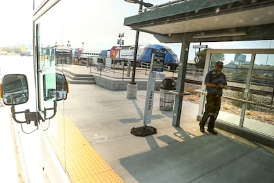 Utah Transit Authority bus operator Briant Thorne is reflected in the windows of a =hybrid electric articulated bus as he prepares to depart the Orem Central FrontRunner station for a test run of the Utah Valley Express on Friday, Aug. 10, 2018. The bus r