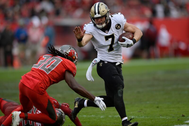 New Orleans Saints quarterback Taysom Hill (7) eludes Tampa Bay Buccaneers cornerback Josh Shaw (30) during the second half of an NFL football game Sunday, Dec. 9, 2018, in Tampa, Fla.