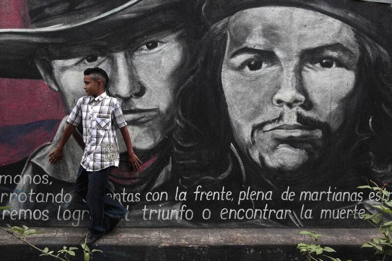A boy walks in front of a mural depicting Nicaragua\'s national hero Augusto C. Sandino, left, and one of Cuba\'s Revolutionary leaders, Ernesto \'Che\' Guevara, in Esteli, Nicaragua, Sunday Jan. 8, 2012.\r\n