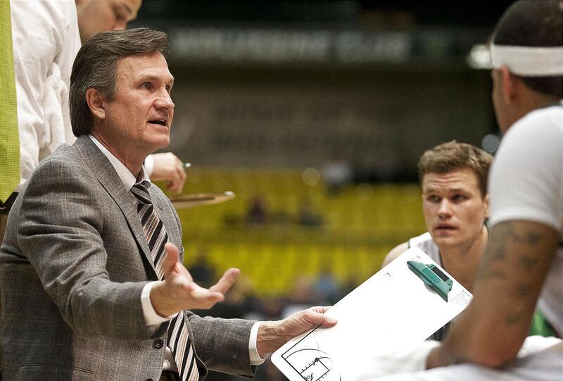 Utah Valley University men's head basketball coach Dick Hunsaker talks with his team during a timeout in a game earlier this season.