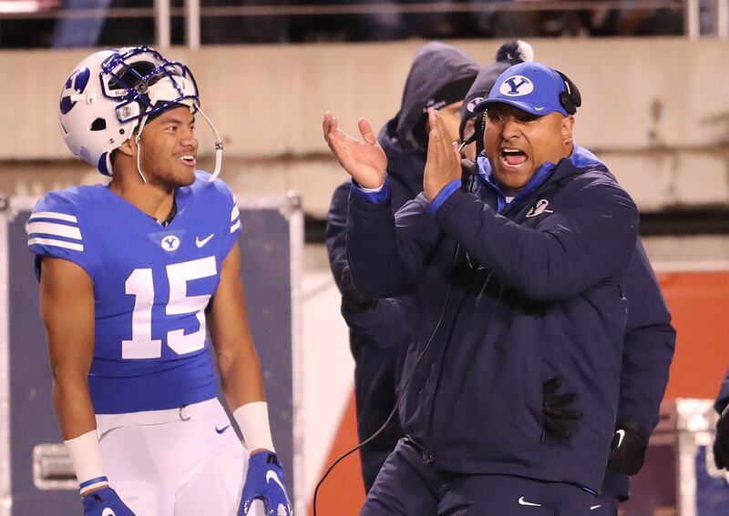 Brigham Young Cougars head coach Kalani Sitake celebrates as BYU and Utah play at Rice-Eccles Stadium in Salt Lake City on Saturday, Nov. 24, 2018.