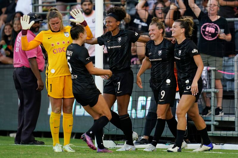 Angel City FC midfielder Savannah McCaskill celebrates with teammates after scoring in the second half of a soccer match.