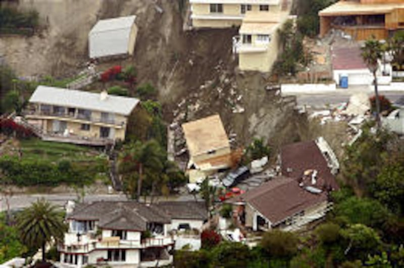 Damaged houses sit on a hillside in Laguna Beach, Calif., after an early morning landslide sent them down the hill Wednesday.