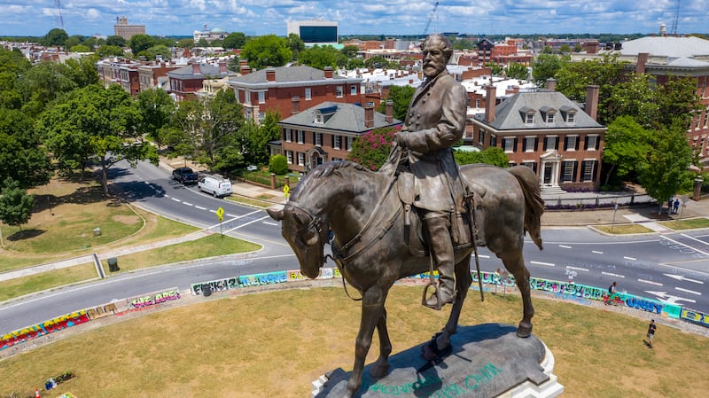 A statue of Robert E. Lee on a horse stands on Monument Avenue in Richmond, Va.