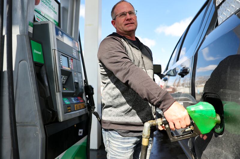 Troy Naylor pumps gas into his truck at a Sinclair in Salt Lake City.