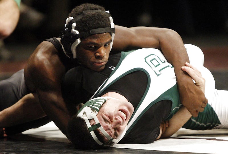 Olympus High's Brandon McBride, left, battles Payson's Brady Loveless in their 171-pound title match Thursday.