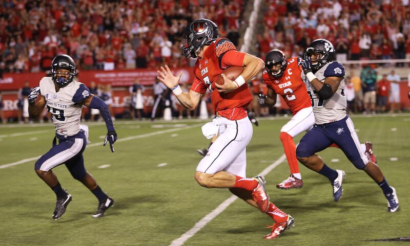 Utah QB Travis Wilson runs in the open as Utah and Utah State play Sept. 11, 2015, at Rice-Eccles Stadium in Salt Lake City.