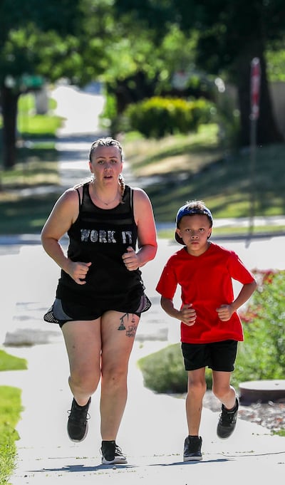 Emily Brainich and her son Kaidyn run up 600 South in Salt Lake City as they train for the Deseret News 5K on Tuesday, July 16, 2019.
