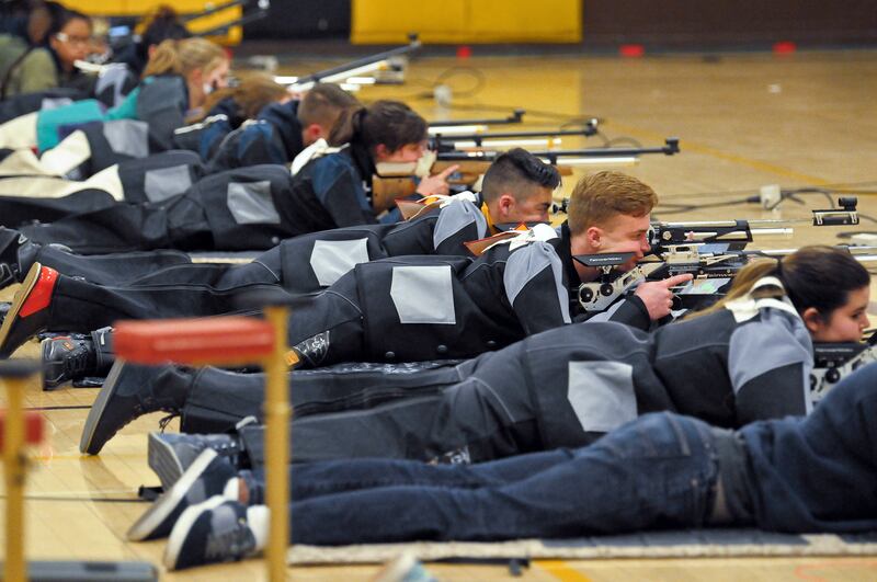 In this March 2, 2018 photo, a group of JROTC shooters compete in the prone position during the 2018 New Mexico Junior Olympic Qualifier for sport and precision air rifles at Cibola High School in Albuquerque, N.M., for the chance to compete at the Nation