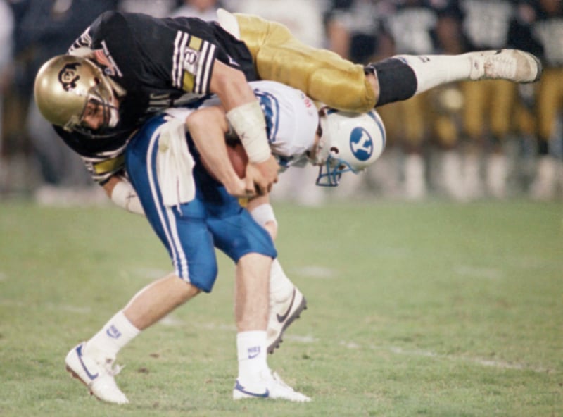 Colorado linebacker Don DeLuzio attempts to stop BYU’s Fred Whittingham during the Freedom Bowl in 1988.