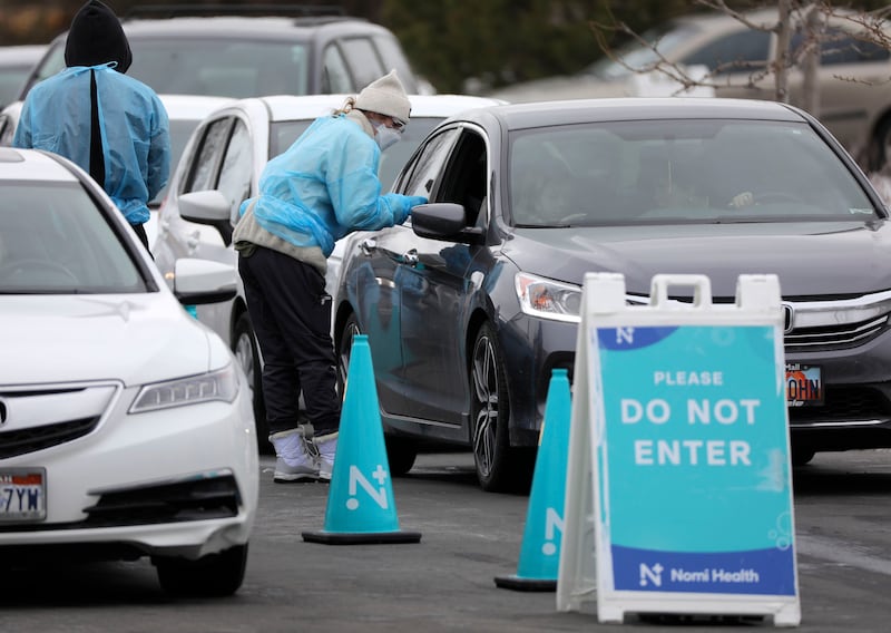 Medical workers test people for COVID-19.