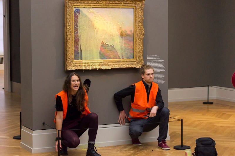 Climate protesters of Last Generation after throwing mashed potatoes at the Claude Monet painting “Les Meules” at Potsdam’s Barberini Museum.