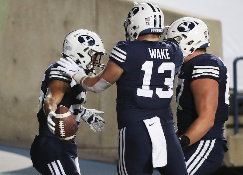 Brigham Young Cougars running back Tyler Allgeier (25) celebrates his touchdown against Texas State with Brigham Young Cougars tight end Masen Wake (13) in Provo on Saturday, Oct. 24, 2020.