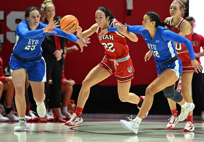 BYU Cougars forward Emma Calvert (25) and BYU Cougars forward Lauren Gustin (12) battle Utah Utes forward Jenna Johnson (22) for the ball as Utah and BYU women play at the Huntsman Center in Salt Lake City on Saturday, Dec. 2, 2023.