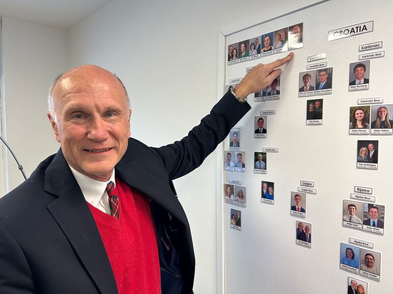 Elder Paul Newton points to his photo on the assignment board of the Adriatic North Mission in Zagreb, Croatia, on March 21, 2025.