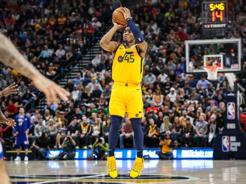Utah Jazz guard Donovan Mitchell (45) shoots a 3-pointer as the Utah Jazz and the Philadelphia 76ers play an NBA basketball game at Vivint Smart Home Arena in Salt Lake City on Thursday, Dec. 27, 2018.