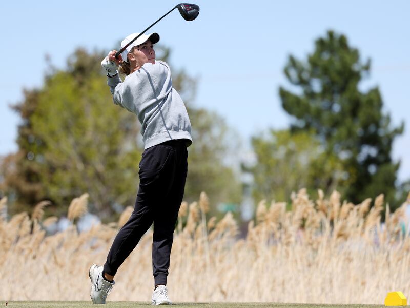 Lone Peak’s Aadyn Long watches a tee shot as she and other girls compete in the 6A golf championship.