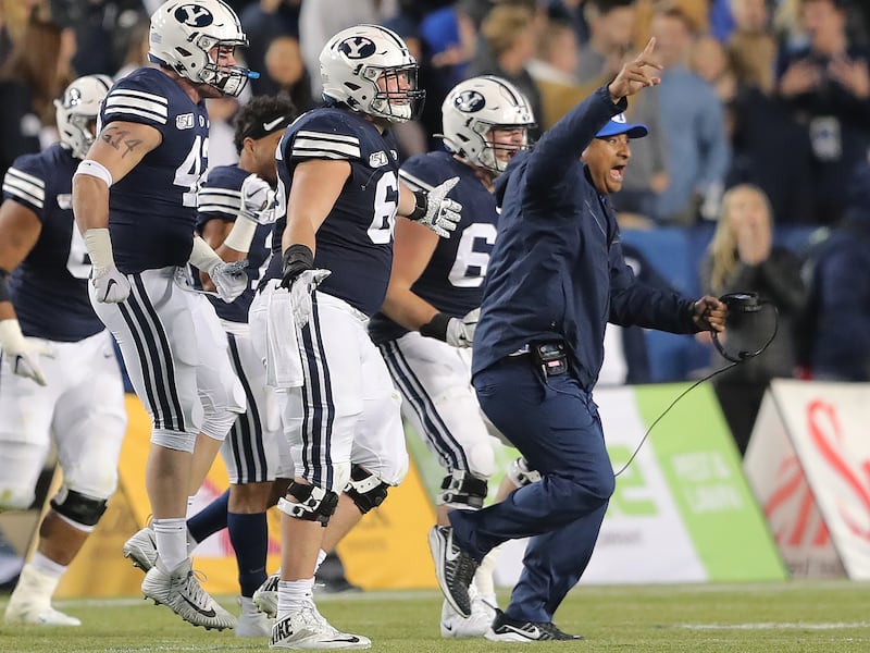 BYU coach Kalani Sitake leads his players out onto the field as BYU defeats Liberty in Provo, Utah, on Saturday, Nov. 9, 2019.
