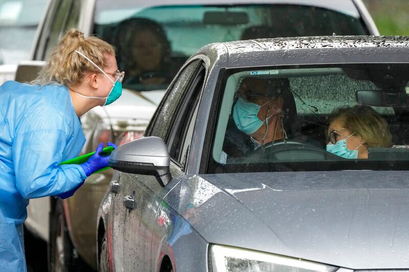 A couple prepare to receive a COVID-19 test.