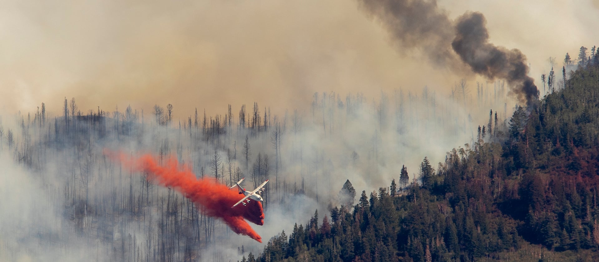 An air tanker drops retardant on the Parleys Canyon Fire west of Park City.