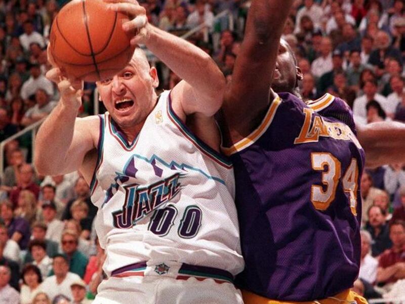 Greg Ostertag pulls a rebound away from Shaquille O"™Neal.