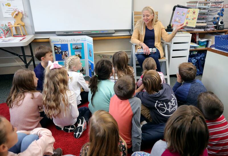 Barbara Homer reads her second grade class a book about verbs at Cottonwood Elementary School in Holladay on Friday, Dec. 7, 2018.