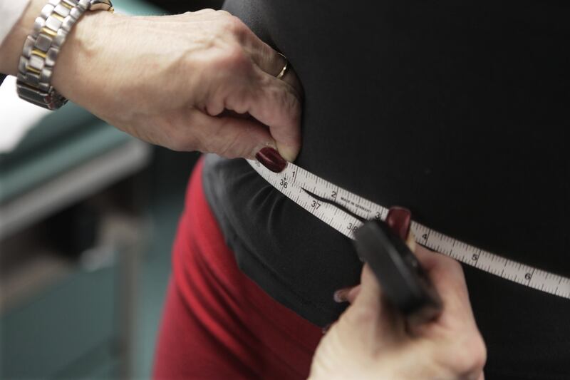 In this Jan. 20, 2010, file photo, a waist is measured during an obesity prevention study in Chicago. A study published Wednesday, April 5, 2017 in the New England Journal of Medicine suggests gaining and losing weight repeatedly may be dangerous for overweight heart patients.