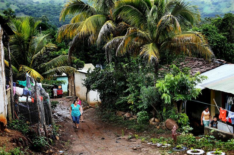Maria Santiago and her mother-in-law, Isolina Sarceño Corado, walk home after visiting Maria's grandmother-in-law in Jerez, Guatemala, on Tuesday, Oct. 16, 2018.