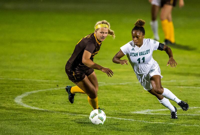 Utah Valley midfielder Doriana Maul (right) drives the ball past a defender during a 2017 game against Wyoming.