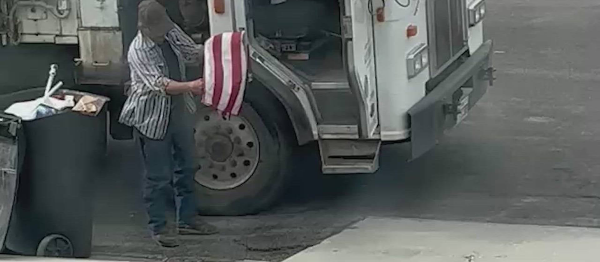 Don Gardner folds a discarded American flag in Huntington, Emery County.