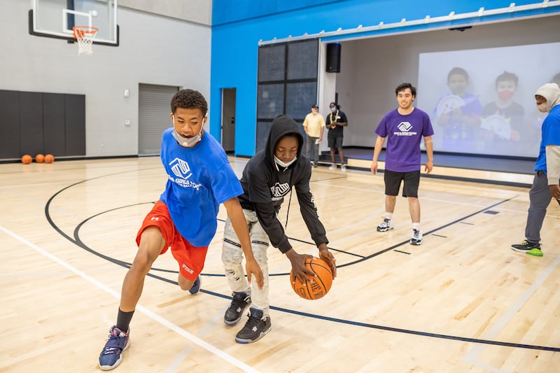 Travis Pfeil and Eritier Ishimael play basketball in the gym at the Spence Eccles Boys & Girls Club in Salt Lake City.