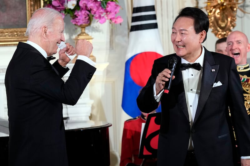 President Joe Biden reacts as South Korea’s President Yoon Suk Yeol sings “American Pie” by Don Mclean on April 26, 2023.