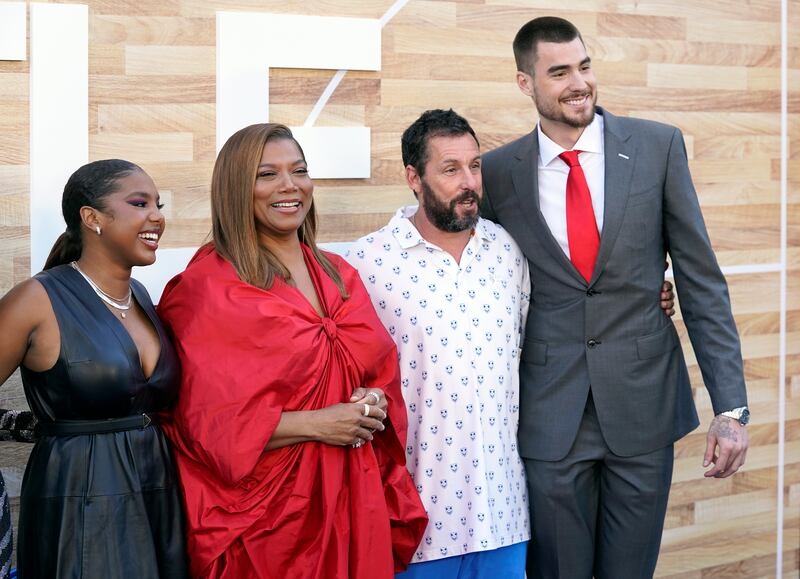 Jordan Hull, Queen Latifah, Adam Sandler and Juancho Hernangomez pose together at the premiere of the film “Hustle.”