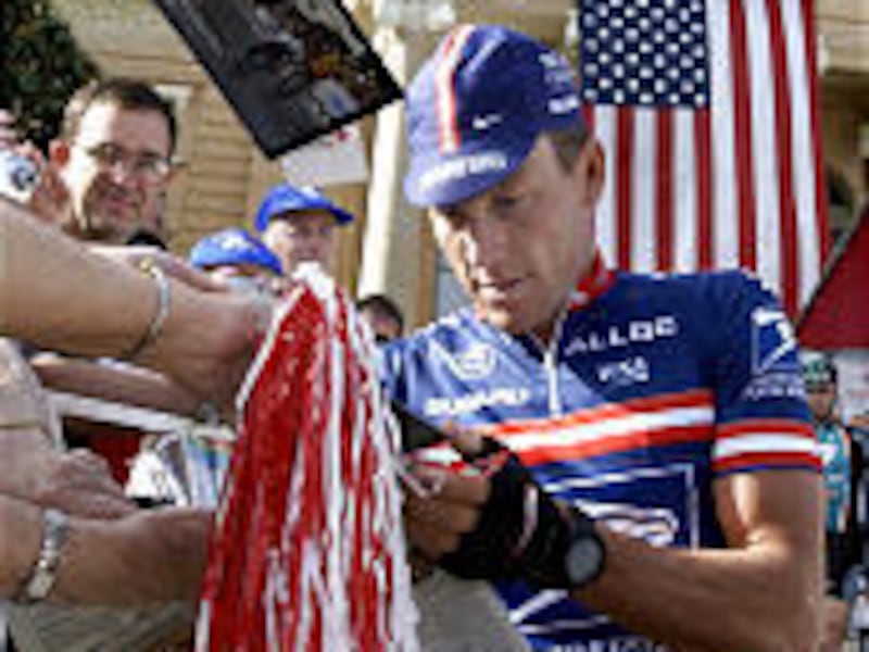 Lance Armstrong signs autographs before the second stage of the Tour de Georgia in Thomaston, Ga., in April. Cycling has become more popular in the United States in recent years thanks in part to Armstrong.