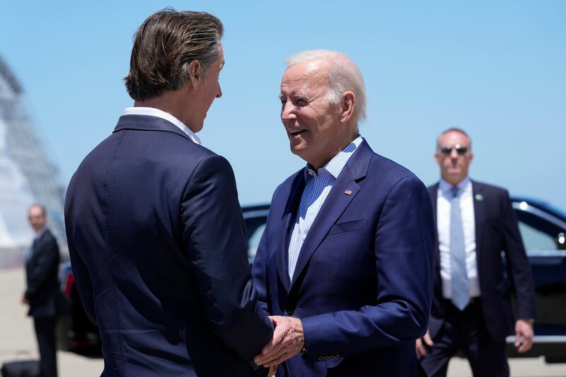 President Joe Biden talks with California Gov. Gavin Newsom as he arrives at Moffett Federal Airfield, Calif., Monday, June 19, 2023.