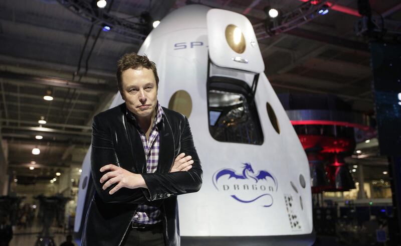 FILE - In this Thursday, May 29, 2014 file photo, Elon Musk, CEO and CTO of SpaceX, listens to a question during a news conference in front of the SpaceX Dragon V2 spacecraft, designed to ferry astronauts to low-Earth orbit, at the headquarters in Hawthor