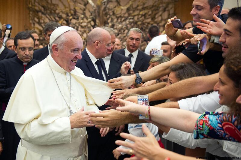 Pope Francis greets faithful during an audience to Parish groups promoting evangelization, in the Paul VI hall at the Vatican, Saturday, Sept. 5, 2015. (L'Osservatore Romano/Pool Photo via AP)