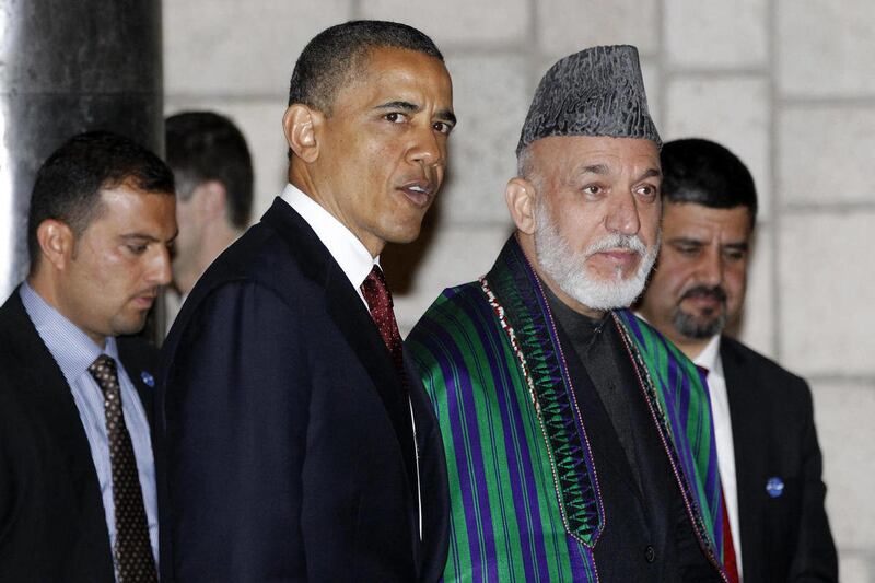 FILE - In this May 2, 2012 file photo, President Barack Obama and Afghan President Hamid Karzai walk together after they signed a strategic partnership agreement at the presidential palace in Kabul, Afghanistan. U.S. troops are still in Afghanistan, nearl