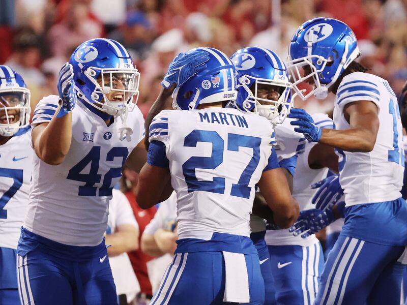 BYU running back LJ Martin celebrates his touchdown at Razorback Stadium in Fayetteville on Saturday, Sept. 16, 2023.