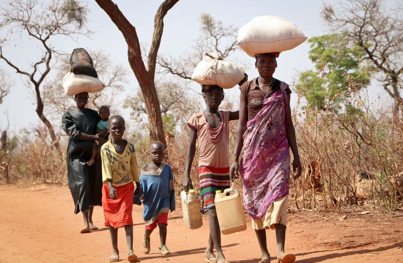 After walking for days, a refugee family arrives in Yida, South Sudan, in 2018.