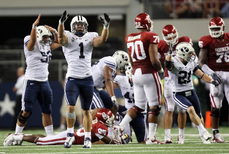BYU’s Jordan Pendleton (1) and other players celebrate a fumble recovery as BYU and Oklahoma play in Texas in 2009.
