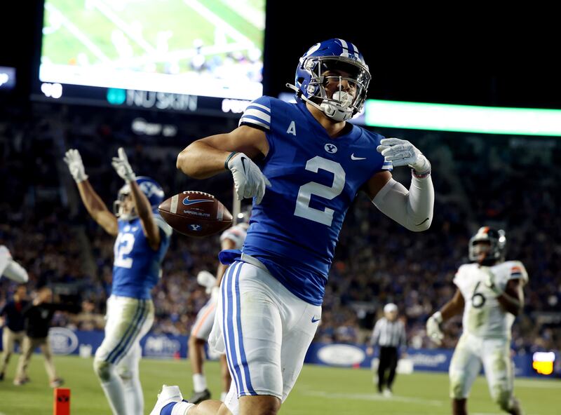 BYU Cougars wide receiver Neil Pau’u celebrates a touchdown against Virginia.