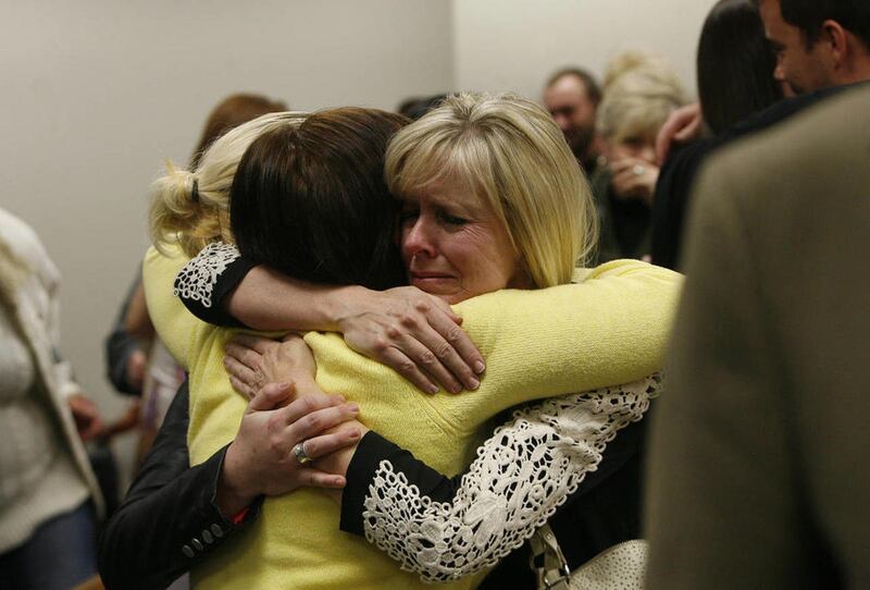 FILE"” Linda Cluff, sister of Michele MacNeill, hugs friends after court was adjourned following the guilty verdicts against Martin MacNeill. MacNeill was found guilty of murder and obstruction of justice early Saturday, Nov. 9, 2013.