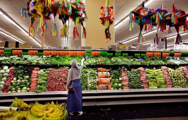 Baraa Huraideen shops at Rancho Market with volunteers in Millcreek on Sept. 12. Her husband is picking up English at work and her sons learn at school. But she has fewer opportunities to practice English.