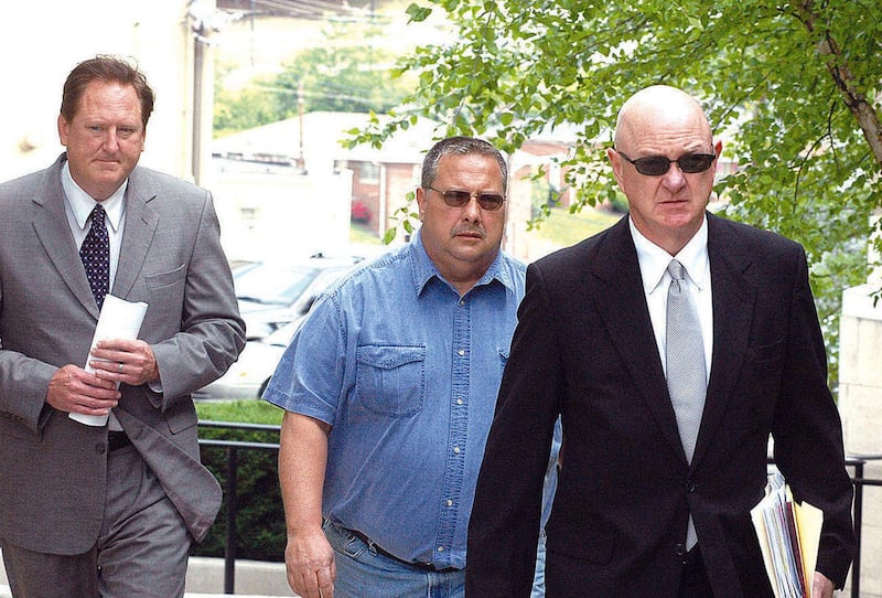 Lawrence Hodge, center, heads to court, flanked by his attorneys Jason E. Williams and Brent Caldwell, Thursday, May 12, 2011, in London, Ky.